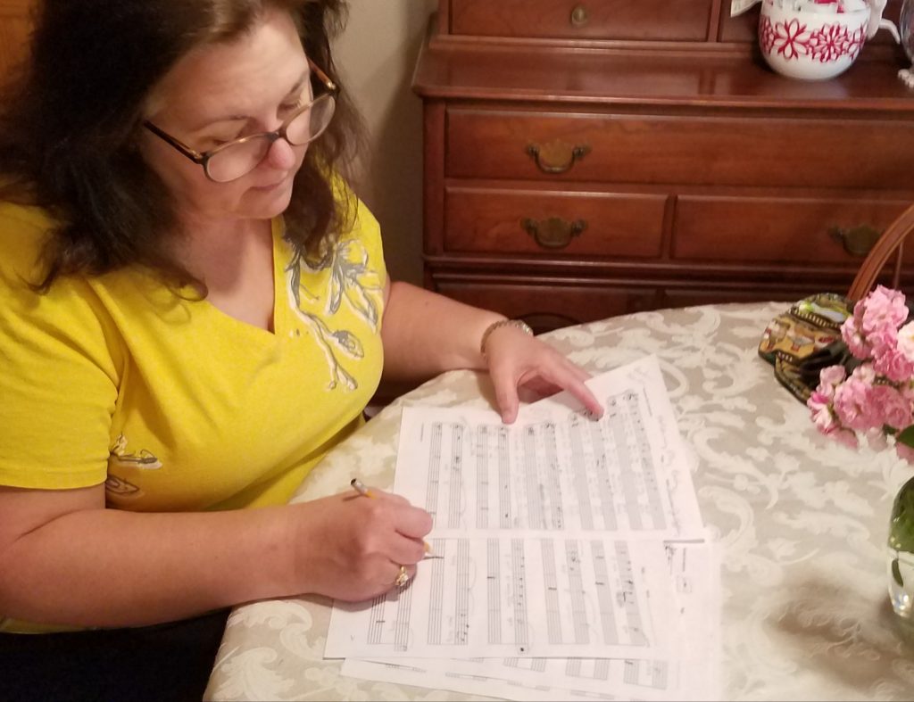 Theresa Jo sits at the kitchen table writing her music.